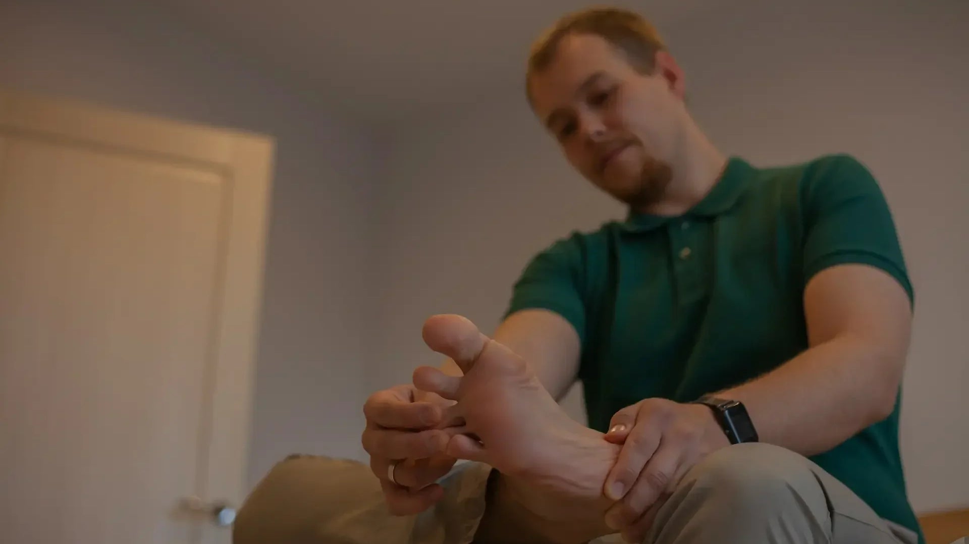 Man holding his foot, reflecting the joint pain associated with gout — photo by Alina Prokudina