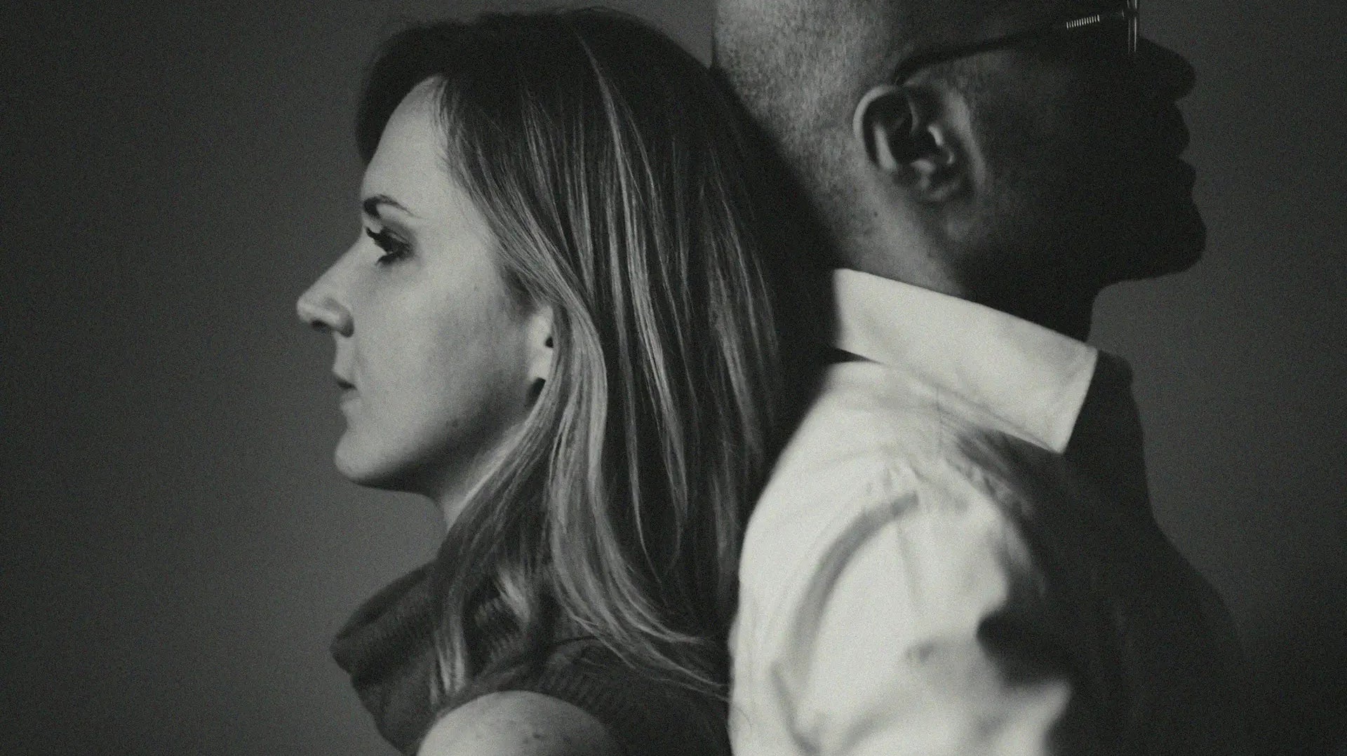 Couple standing back to back, reflecting emotional distance that sex therapy can help address — photo by Alex Sheldon