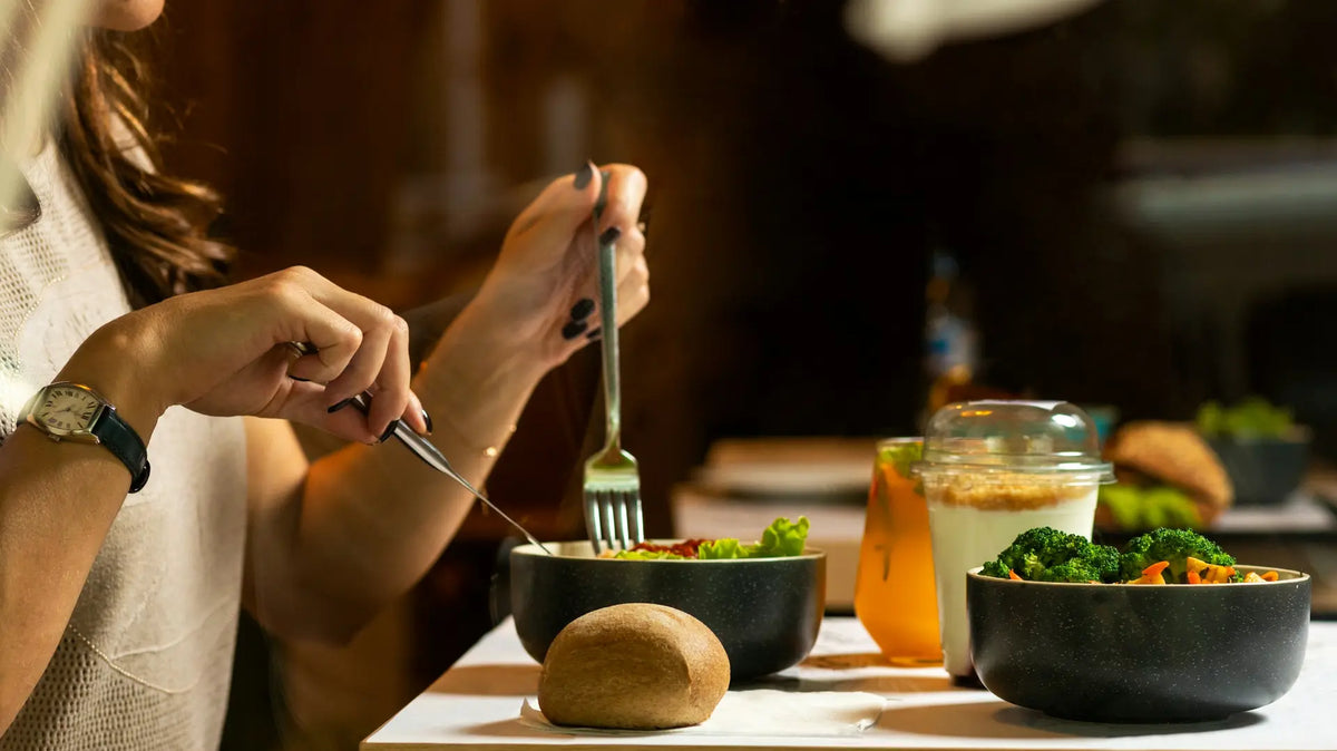 Woman eating a healthy meal of salad and vegetables — photo by Farhad Ibrahimzade