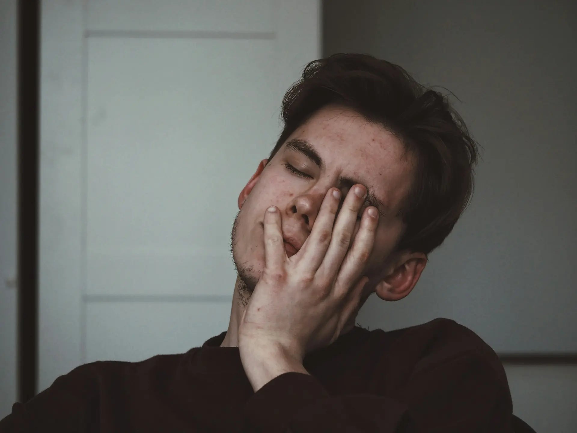 Man rubbing his tired eyes, reflecting fatigue linked to low immunity — photo by Adrian Swancar
