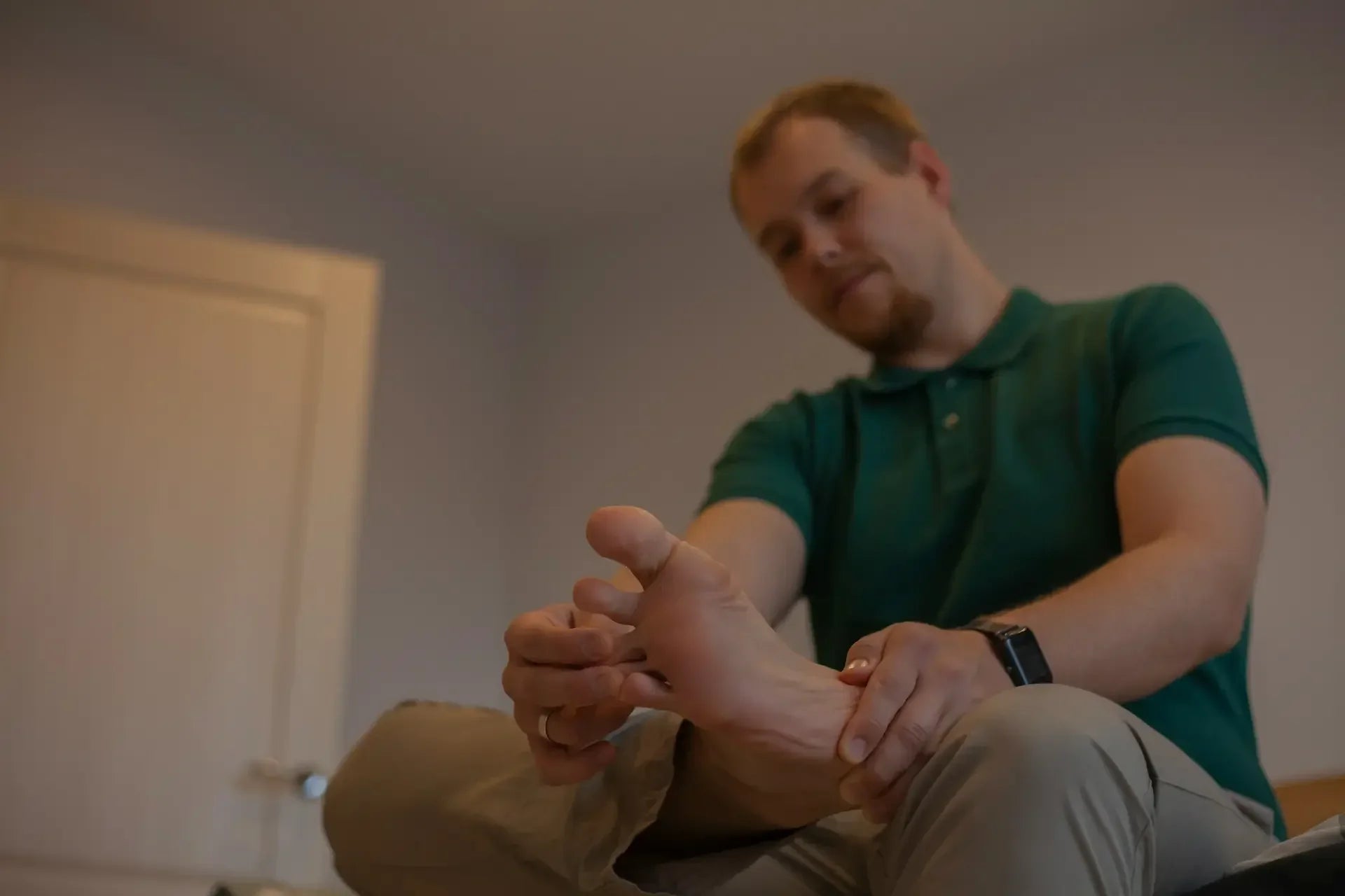 Man holding his foot, reflecting the joint pain associated with gout — photo by Alina Prokudina
