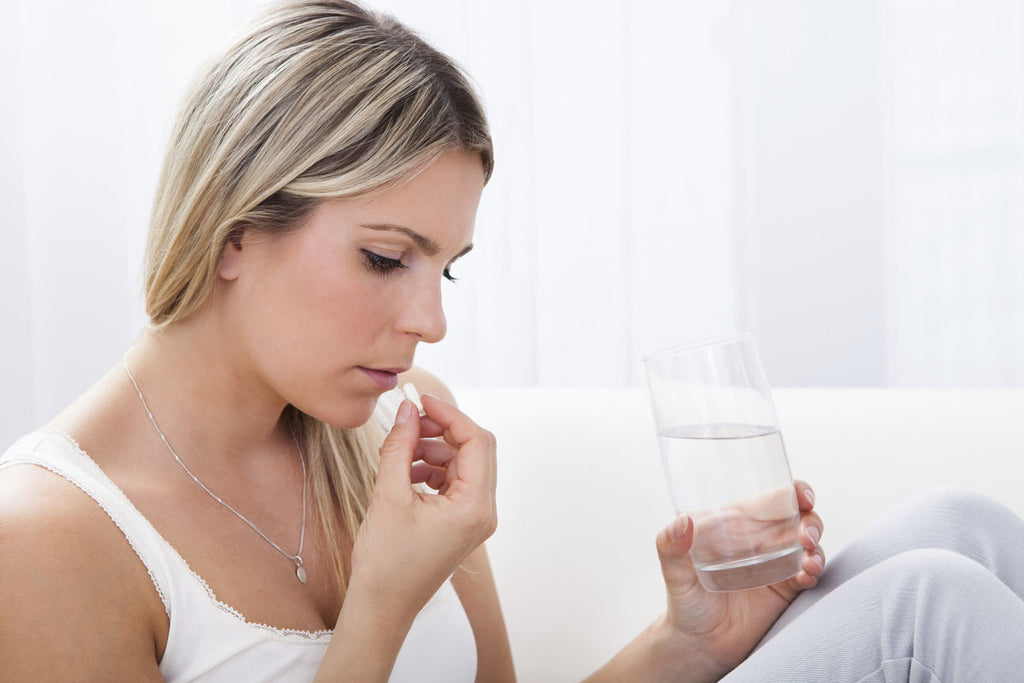 woman drinking pill